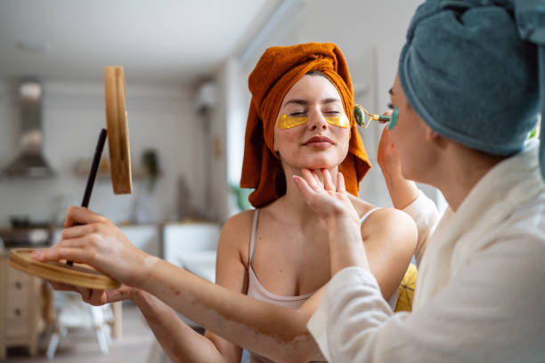istock Two young women, roommates, doing beauty routine at their shared apartment. 2158549864