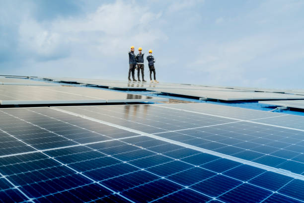 istock engineer man inspects construction of solar cell panel or photovoltaic cell by electronic device. Industrial Renewable energy of green power. factory worker working on tower roof. 2158549874