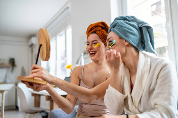 istock Two young women, roommates, doing beauty routine at their shared apartment. 2158549913