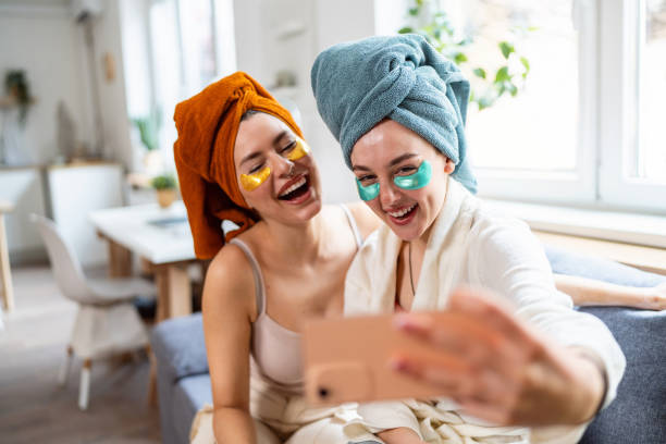 istock Two young women, roommates, taking selfies while doing beauty routine at their shared apartment. 2158549923