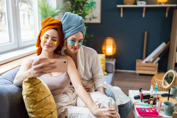 istock Two young women, roommates, taking selfies while doing beauty routine at their shared apartment. 2158549935