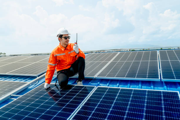 istock engineer man inspects construction of solar cell panel or photovoltaic cell by electronic device. Industrial Renewable energy of green power. factory worker working on tower roof. 2158550961