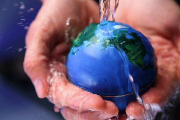 istock Water pouring on planet earth 2158551025