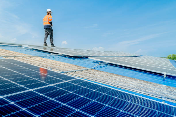 istock engineer man inspects construction of solar cell panel or photovoltaic cell by electronic device. Industrial Renewable energy of green power. factory worker working on tower roof. 2158551038