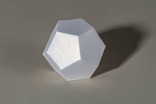3D silver pentagon shaped paper craft on a gray background