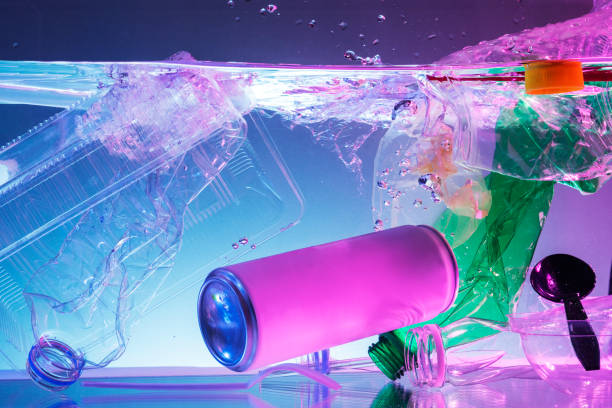 istock Plastic and other waste polluting the ocean neon background 2158553173