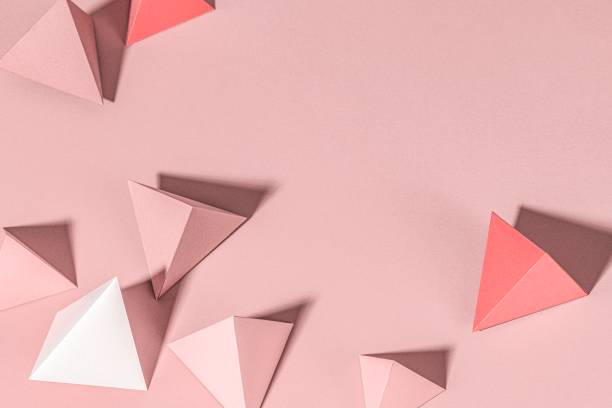 istock 3D pink pyramid paper craft on a pink background 2158553227