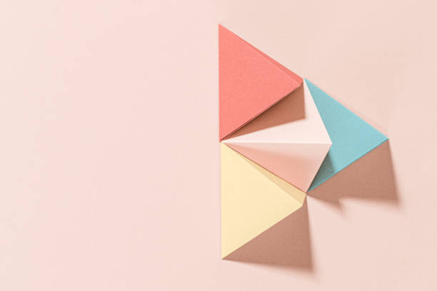 istock 3D pastel pyramid paper craft on a pink background 2158553237