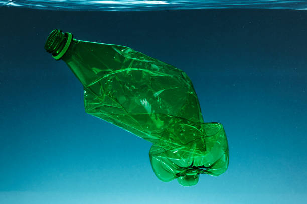 istock Crumpled plastic bottle polluting the ocean 2158553499