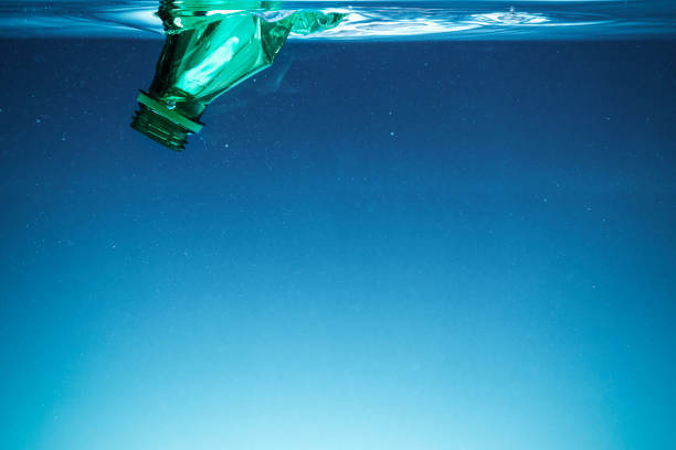 istock Crumpled plastic bottle polluting the ocean 2158553582