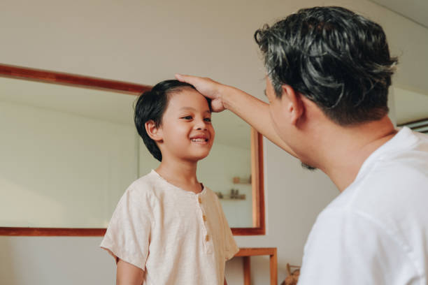 istock Happy Asian kid with his father getting ready in the morning. 2158554547