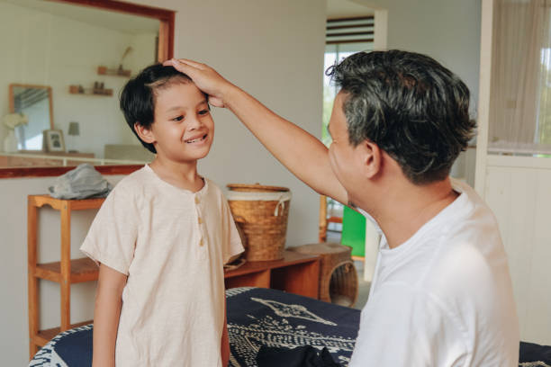 istock Happy Asian kid with his father getting ready in the morning. 2158554581