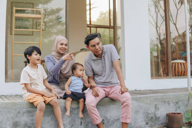istock Family spending their leisure time outside house. 2158554599