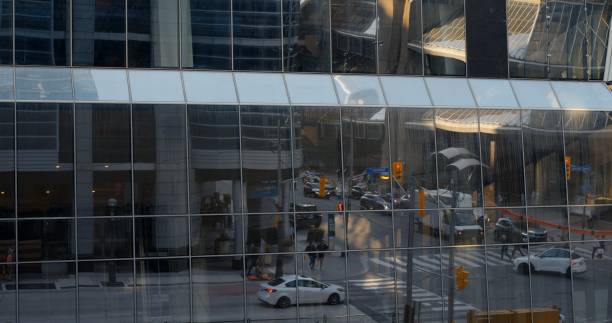 Glass building reflects vibrant modern city with highrise structures, bustling streets, and contemporary architecture, creating busy urban environment full of life and corporate buildings