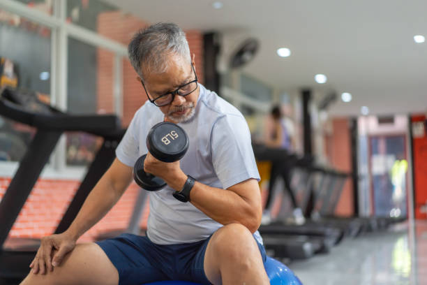istock senior men play with exercise equipment in the gym. 2158556212