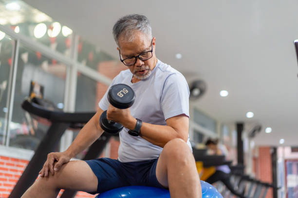 istock senior men play with exercise equipment in the gym. 2158556228