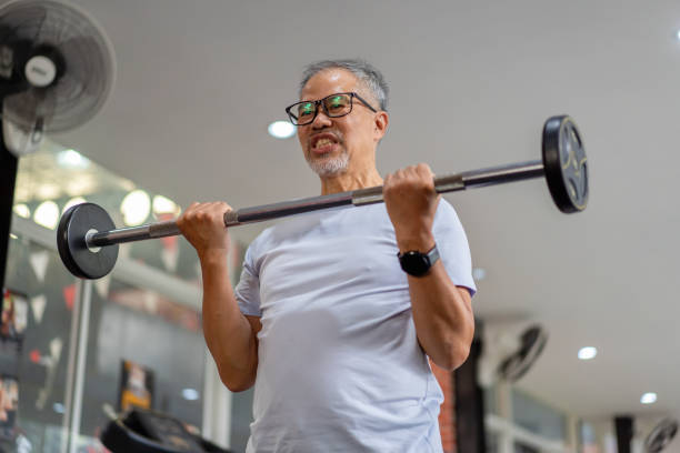 istock senior men play with exercise equipment in the gym. 2158556232