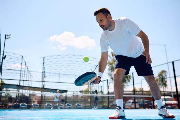 istock Paddle tennis player hitting the ball while playing match on the court. 2158556978