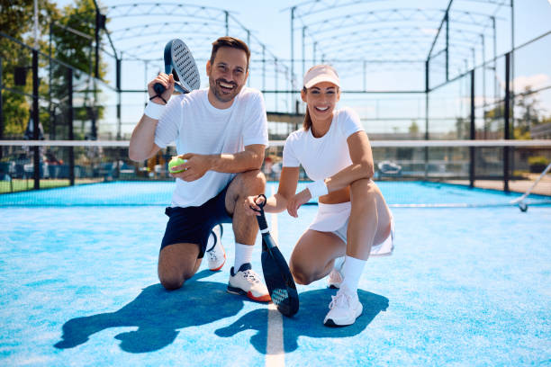happy paddle tennis doubles players on the court looking at camera. - padel imagens e fotografias de stock