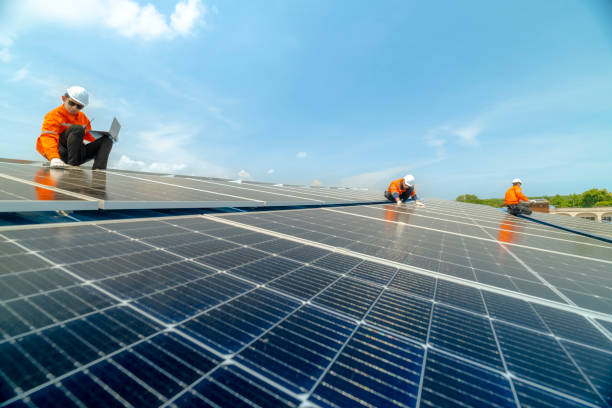 istock engineer man inspects construction of solar cell panel or photovoltaic cell by electronic device. Industrial Renewable energy of green power. factory worker working on tower roof. 2158557728