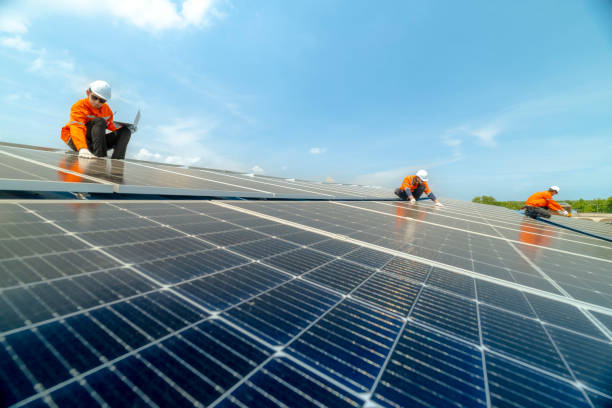istock engineer man inspects construction of solar cell panel or photovoltaic cell by electronic device. Industrial Renewable energy of green power. factory worker working on tower roof. 2158557748