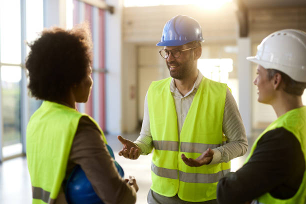 istock Team of happy civil engineers talking at construction site. 2158557796
