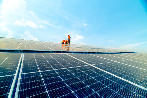 istock engineer man inspects construction of solar cell panel or photovoltaic cell by electronic device. Industrial Renewable energy of green power. factory worker working on tower roof. 2158557810