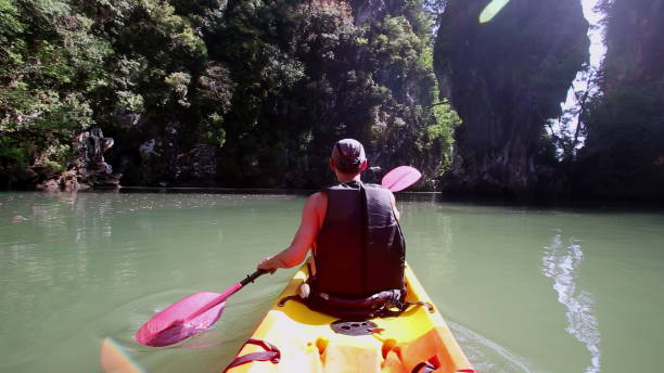 istock Man engages in kayaking making water splashes with paddle 2158557907