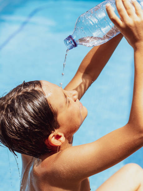 istock Drinking water from bottles in the hot weather. heat wave 2158560814