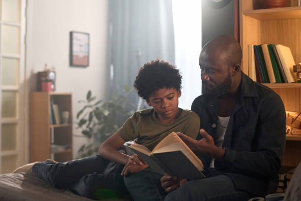 istock Loving Parent and Child Reading Book Together 2158561491