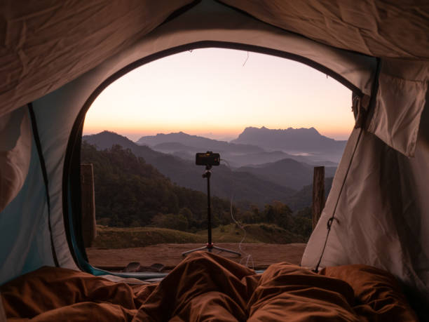 istock Doi Luang Chiang Dao mountain at dawn scene from inside camping tent and smart phone on tripod. Chiang Mai - Thailand 2158563241