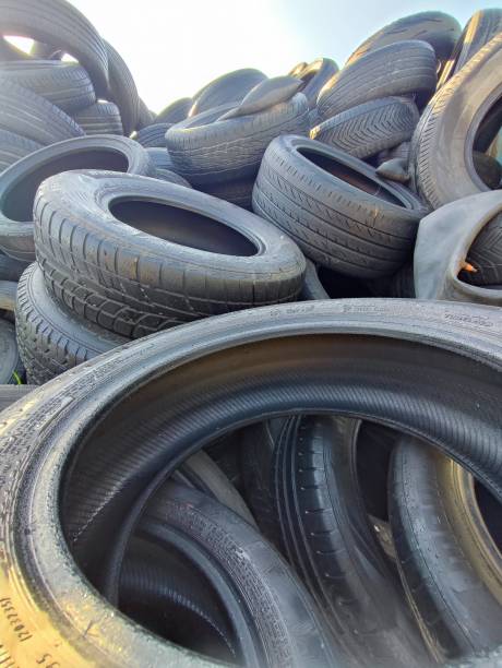 istock Stack of used car tyres ready for disposal. Environment, ecology and recycling concept. 2158565943