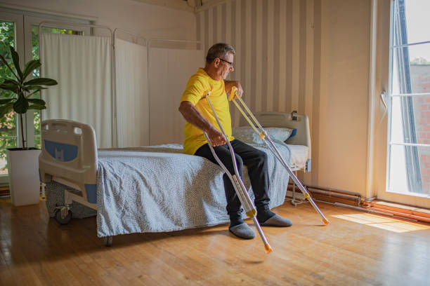 istock Nursing home, an elderly man uses crutches to move 2158566888