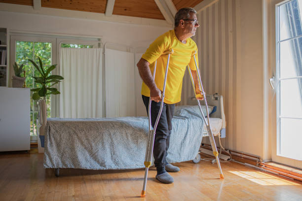 istock Nursing home, an elderly man uses crutches to move 2158566984