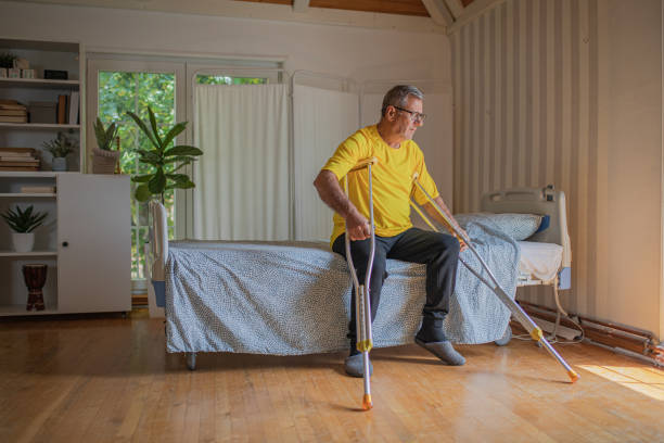 istock Nursing home, an elderly man uses crutches to move 2158566998