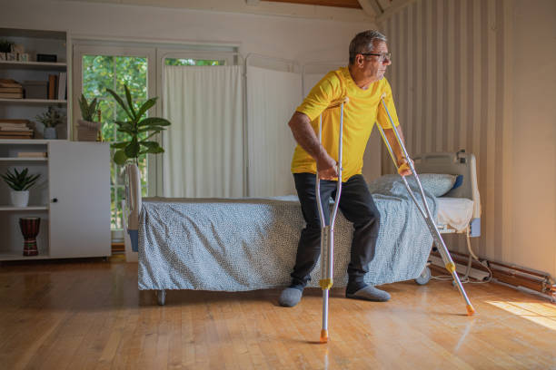istock Nursing home, an elderly man uses crutches to move 2158567021