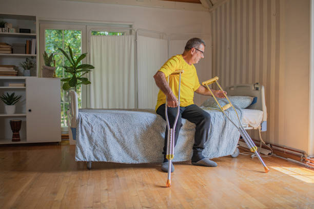 istock Nursing home, an elderly man uses crutches to move 2158567023