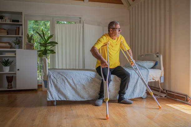 istock Nursing home, an elderly man uses crutches to move 2158567040