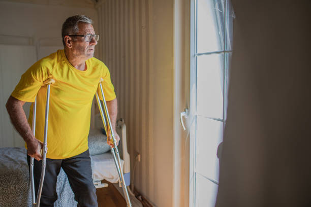 istock Nursing home, an elderly man uses crutches to move 2158567084