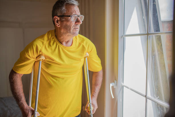 istock Nursing home, an elderly man uses crutches to move 2158567092
