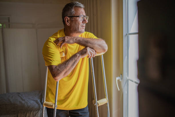 istock Nursing home, an elderly man uses crutches to move 2158567107