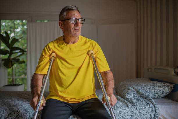 istock Nursing home, an elderly man uses crutches to move 2158567141