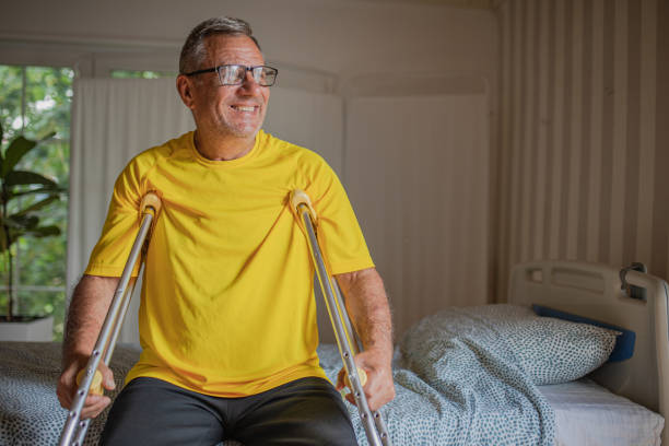 Portrait of smiling man with crutches for walking