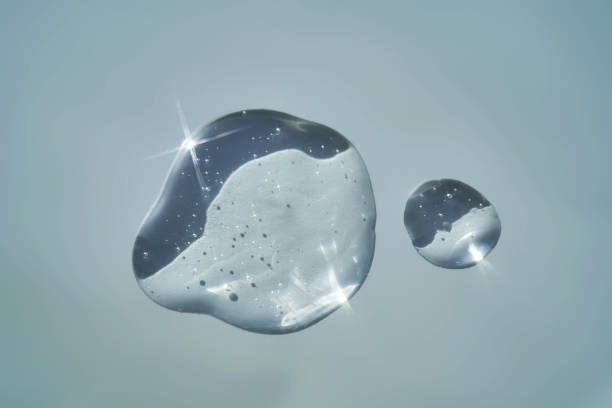 istock Drop of serum shimmering in the sun on a blue background. 2158567174