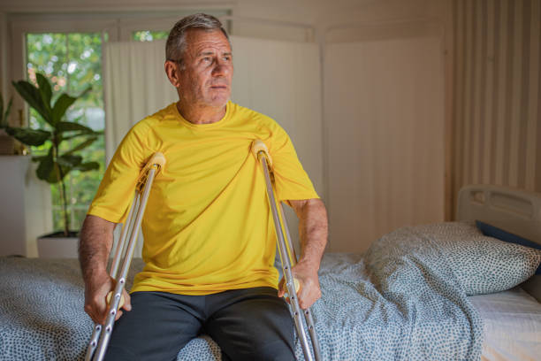 istock Nursing home, an elderly man uses crutches to move 2158567186