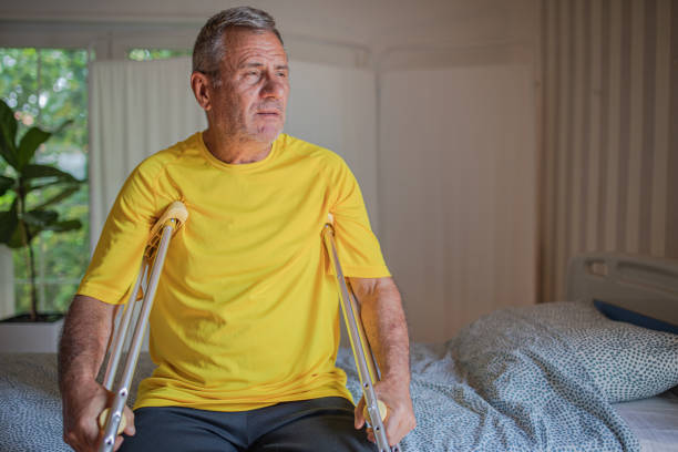 istock Nursing home, an elderly man uses crutches to move 2158567190