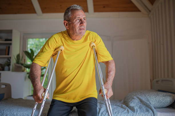istock Nursing home, an elderly man uses crutches to move 2158567191