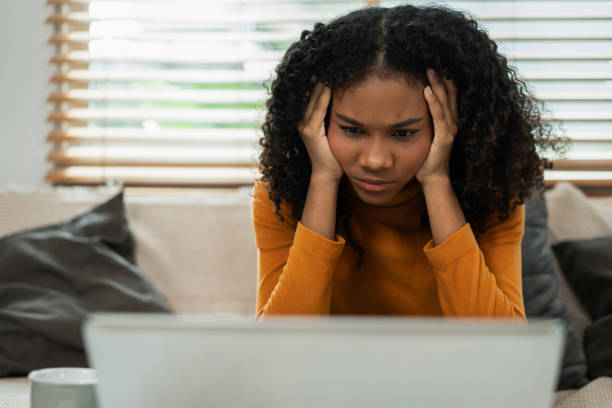 istock Sad and stress young female sitting on the sofa, feel tired, lonely from working for poor work. 2158568627