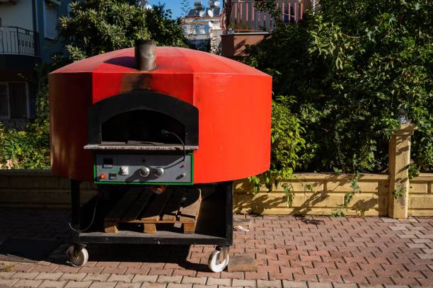 istock Large domed red metal outdoor pizza oven. 2158569739