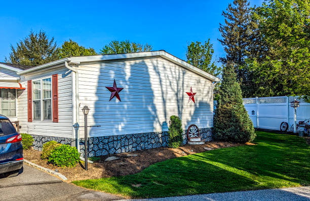 istock White Mobile, Manufactured, Prefab Home With Red Stars And Well-Kept Yard 2158569898